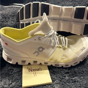 On Running White and Yellow Athletic Shoes with CloudTec Cushioning